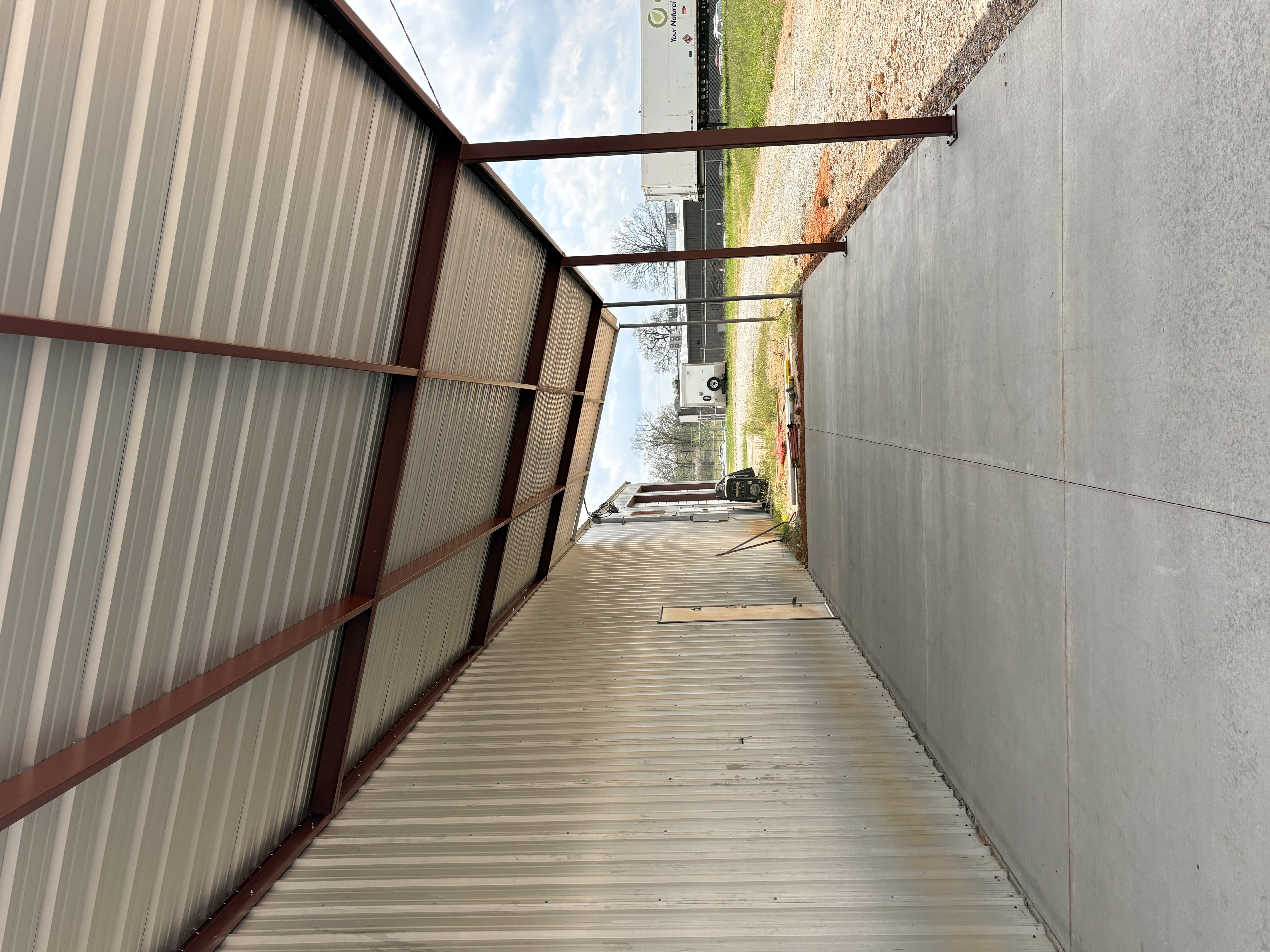 Metal building front with roll-up door by Turner Structures